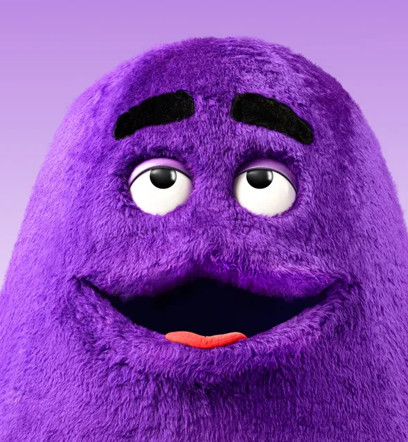 Headshot of Grimace, set against a smooth purple gradient background.