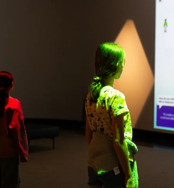 Image of children under coloured spotlights